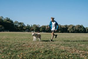 A man running with his dog in park - Darren Yaw released
